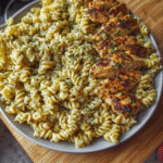 Creamy garlic parmesan chicken pasta served in a bowl with herbs on top.