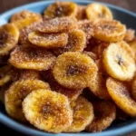Cinnamon-sugar air fryer banana chips in a bowl, a healthy snack option.