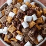 Delicious S'mores Puppy Chow mixture in a bowl, perfect for sweet snacking.