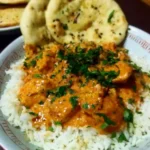 Delicious homemade butter chicken served with rice and naan bread.