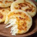 Delicious arepas filled with melting cheese, showcasing the ultimate comfort food.