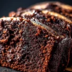Loaf of rich Chocolate Espresso Banana Bread on a wooden cutting board