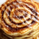 Delicious cinnamon roll pancakes topped with icing