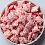 Bowl of strawberry shortcake puppy chow with strawberries on top