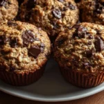 Three delicious oatmeal chocolate chip muffins on a plate