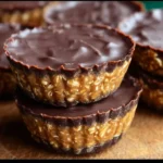 Homemade Peanut Butter Oat Cups stacked on a white plate