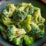 Creamy garlic parmesan broccoli dish garnished with herbs