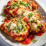 Crispy Chicken Parmesan served with marinara sauce and melted cheese