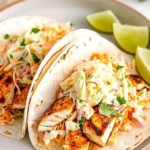 Delicious grilled fish tacos topped with fresh cabbage slaw