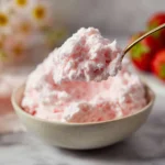 Light Cottage Cheese Jello Salad in a bowl, topped with fruits and nuts.