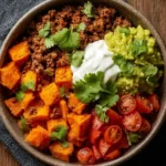 Colorful sweet potato taco bowl with toppings