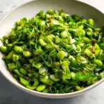 Chili Crisp Snap Pea Salad with colorful vegetables and a spicy chili crisp topping