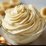 Delicious cottage cheese banana pudding in a glass bowl topped with banana slices.