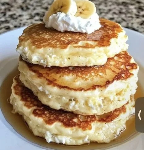 Fluffy banana pancakes made with cottage cheese topped with fresh banana slices