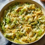 Garlic Alfredo pasta topped with tender cabbage in a creamy sauce