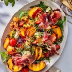 Grilled nectarine burrata salad with prosciutto on a plate