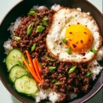 Korean ground beef rice bowl topped with green onions and sesame seeds