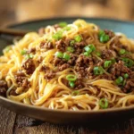 Delicious bowl of Mongolian ground beef noodles with vegetables and spices