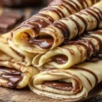 Stack of fluffy basic pancakes served with syrup and berries