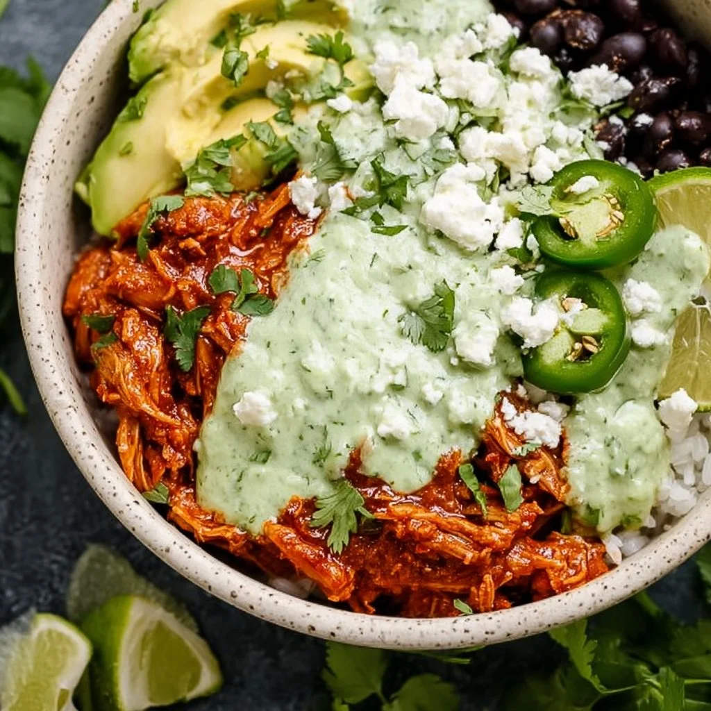 Delicious Chicken Tinga Bowl topped with fresh vegetables and avocado.