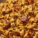 Creamy cowboy butter chicken pasta served in a bowl with fresh herbs