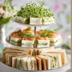 Cucumber and herb cream cheese sandwiches on a platter, perfect for tea time