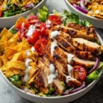 High protein chicken taco salad bowl with fresh ingredients and toppings