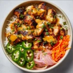 Delicious hot honey chicken bowl with crispy chicken and spicy honey drizzle