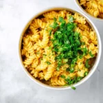 A serving of protein pasta topped with fresh vegetables and sauce