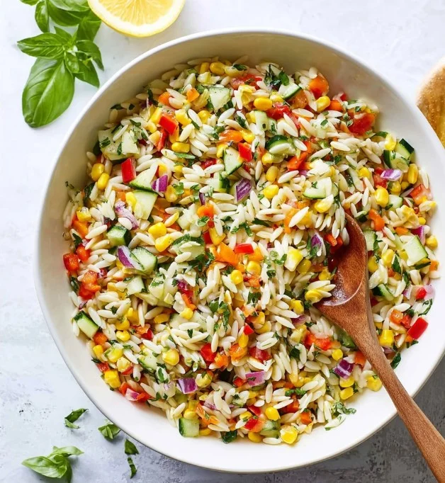 Colorful Rainbow Orzo Salad with fresh vegetables and herbs