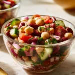 Colorful zesty bean salad with fresh vegetables and herbs in a bowl