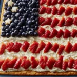 American Flag Fruit Pizza topped with strawberries, blueberries, and whipped cream