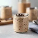 Bowl of chocolate protein overnight oats topped with fruits and nuts