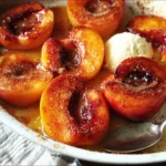 Cinnamon sugar baked peaches served in a rustic dish for a delightful dessert.