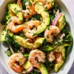 Citrus Shrimp and Avocado Salad garnished with fresh herbs and citrus dressing