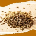 A glass of cumin water on a wooden table for weight loss and health benefits.