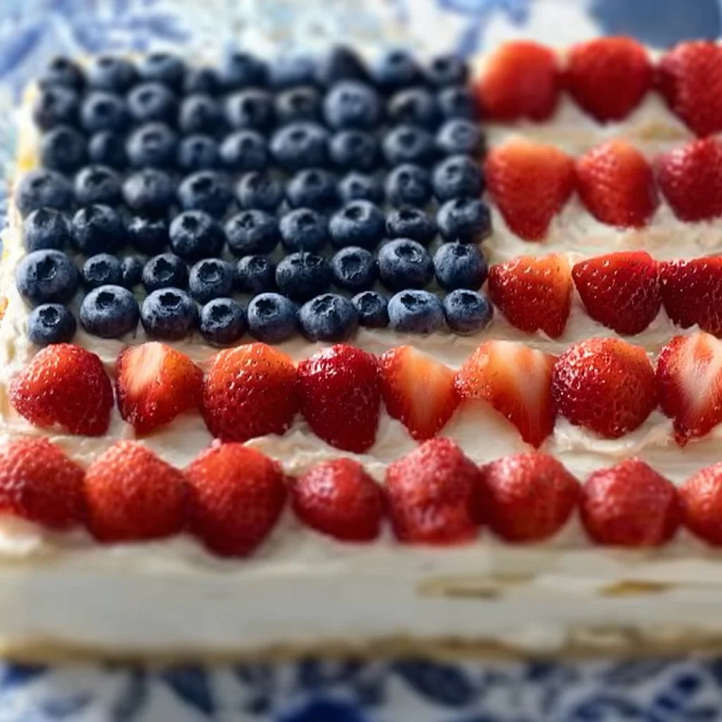 Flag fruit pizza on a sugar cookie crust topped with colorful fruits