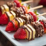 Colorful fruit kabobs on skewers ready for a summer BBQ dessert