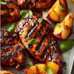 Grilled peaches served with balsamic chicken on a plate