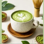 Healthy matcha latte served in a cup with frothy green tea milk on top.