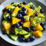 Mango Cucumber Salad with Blueberries and Avocado in a vibrant bowl