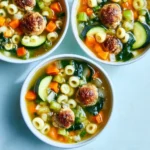 A bowl of minestrone soup with turkey meatballs and fresh vegetables.