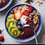 Ninja Creami smoothie bowls topped with fresh fruits and granola.