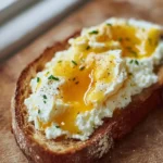 Delicious Egg and Ricotta Toast topped with fresh herbs