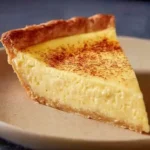 Slice of traditional Old Fashioned Custard Pie on a plate