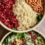 A vibrant bowl of The Scala Chopped Salad with fresh vegetables and dressing.