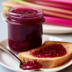 Homemade rhubarb jam spread on toasted bread with Brie cheese