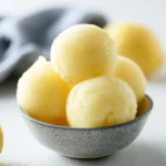 Delicious bowl of homemade lemonade sorbet with lemons